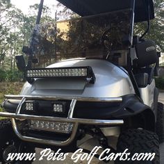 a silver golf cart parked in front of a house