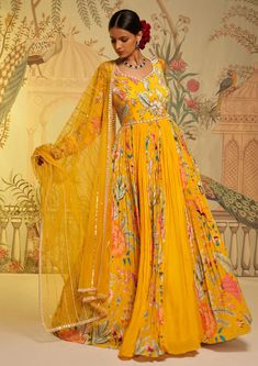 Editor's Note The yellow amber floral anarkali and dupatta is a stunning ensemble that exudes timeless charm and elegance. The vibrant yellow color and intricate floral motifs create a captivating look, while the flowing silhouette adds grace and movement. Paired with a matching dupatta, this outfit is perfect for special occasions and celebrations. Color: Yellow Fabric: Anarkali: crepe silk & georgette crepe, dupatta: swiss net Components: Anarkali and dupatta Occasion: Festive Fit: Fitted at w Floral Anarkali, Yellow Anarkali, Cozy Sweater Dress, Floral Frocks, Beautiful Maxi Dresses, Floral Embroidered Top, Trendy Blouse Designs, Anarkali Dress, Frock Design