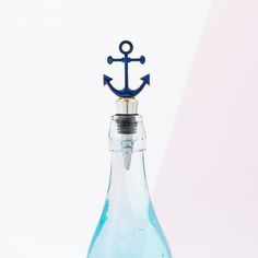 an anchor bottle stopper with blue liquid in it