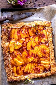 a pie with peaches and sauce on it