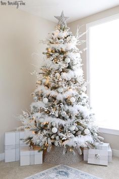 a white christmas tree in a living room