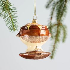 a glass ornament hanging from a christmas tree