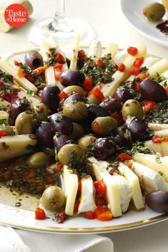 a platter filled with cheese and olives