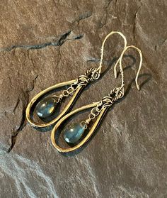 These beautiful, bohemian style dangles feature handcrafted, artisan, gold bronze hoops, with smooth, blue flash labradorite gemstones. The gems are wire wrapped in gold filled wire. The gorgeous ear wires are handcrafted in gold bronze. Total length is approximately 2 inches.  Earrings will arrive in a gift box.  Please ensure that your correct address is listed when you place your order. Terra Glass and Gems is not responsible for lost, stolen, damaged, or misplaced packages. Bohemian Wire Wrapped Earrings For Jewelry Making, Bohemian Dangle Brass Jewelry, Bohemian Brass Dangle Jewelry, Artistic Dangle Jewelry For Festivals, Bohemian Wire Wrapped Adjustable Chandelier Earrings, Bohemian Teardrop Jewelry With Ear Wire, Bohemian Dangle Earrings For Jewelry Making, Bohemian Wire Wrapped Dangle Jewelry, Bohemian Wire Wrapped Teardrop Jewelry