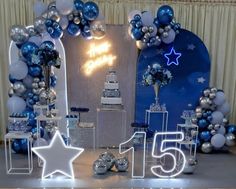 a table with balloons and decorations for a 50th birthday party in blue, silver and white