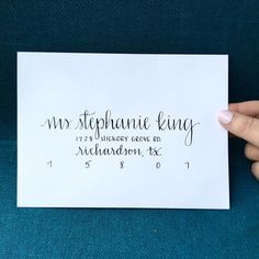 a person holding up a piece of paper with the words miss stephanie king on it