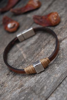 LEATHER STRAP WITH MAGNET CLOSURE - MEN'S BRACELET Discreet, this bracelet to the minimalist line adds a detail to the wrist. Hand-dyed, each piece is unique, made with vegetable tanned leather. With a slightly shiny finish, it is decorated with a small square ornament surrounded by thread. ▶ SIZES AVAILABLE: 14 to 22 cm / 5.5 to 8.7 inches. If you want a different size, select the closest option, add the item to the basket and write down the desired size in - note to seller. ▶ WRIST MEASUREMENT Artisan Leather Bracelet With Leather Strap, Handmade Leather Bracelets For Everyday, Handmade Leather Bracelet For Everyday, Artisan Leather Strap Bracelet, Everyday Handmade Leather Bracelets, Handmade Brown Leather Bracelet For Gift, Handmade Brown Leather Bracelet Gift, Brown Waxed Finish Bracelets As Gift, Masculine Brown Leather Bracelets