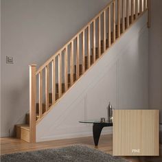 an empty room with a glass table and wooden stairs