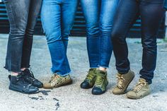 four people standing next to each other with their feet on one another's ankles