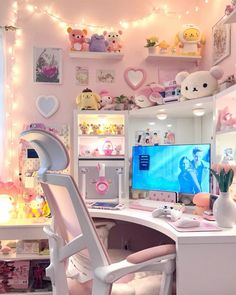 a white desk topped with a computer monitor next to a window filled with stuffed animals