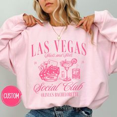 a woman wearing a pink sweatshirt with las vegas on it and the words social club