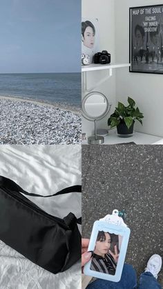 a person sitting on a bed next to the ocean and holding a bag with a photo hanging from it