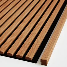 wooden slats are lined up against the white background, and one is brown in color