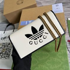 Description Gucci x Adidas Wallet With Chain White For Women, Women’s Bags 7.5in/19cm GG 621892 UZ3BG 8847 Part of the adidas x Gucci collection, this chain wallet features the Gucci Trefoil print. Emblematic Houses motifs mix with those of the historic sportswear brand adidas. The collection sees both heritages encoded in a trio of lines, where adidas and Gucci combine archival emblems. Creative Director, Alessandro Michele pulls inspiration from his memories of the 80s and 90s for a collection Adidas X Gucci, Gucci X Adidas, Wallet With Chain, Gucci Collection, Chain Wallet, Alessandro Michele, Adidas X, Sportswear Brand, Wallet Chain