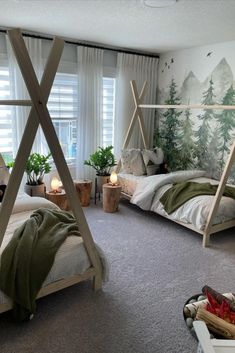 a bedroom with a canopy bed in the middle and green trees on the wall behind it