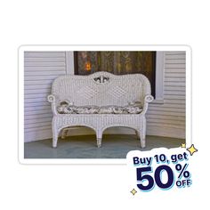 a white wicker couch sitting in front of a house with the price tag 50 off