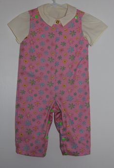 Girls floral print romper with snap crotch for easy changing. Comes with plain light yellow short sleeved shirt. This is a unique item and although I may use the same pattern, no two items are exactly the same. Spring Cotton Bubble Romper With Short Sleeves, Cotton Bubble Romper With Short Sleeves For Spring, Cotton Short Sleeve Bubble Romper For Spring, Playful Short Sleeve Onesie For Spring, Fitted Short Sleeve Bodysuit For Playwear, Casual Fitted Bubble Romper With Short Sleeves, Fitted Short Sleeve Onesie For Spring, Printed Short Sleeve Bodysuit For Summer, Fitted Short-sleeved Onesie For Spring