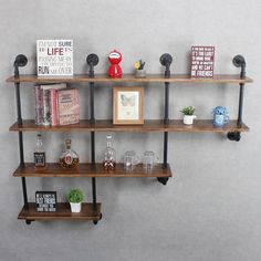 three wooden shelves with books and glasses on them