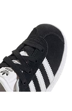 Initially designed in '91 as a training shoe for top athletes, the iconic Gazelle sneaker has been refreshed with stretchy laces for your little athlete. Pull-on style with elastic laces Leather and synthetic upper/textile lining/rubber sole Imported Sporty Black Sneakers With White Laces, Black Sporty Sneakers With White Laces, Black Lace-up Sneakers With White Laces, Non-slip High-top Sneakers For Training, Adidas Non-slip Sneakers For Sports, Adidas Sports Sneakers, Adidas Training Sneakers With Laces, Adidas Athleisure Running Shoes With Elastic Laces, Adidas Low-top Training Sneakers