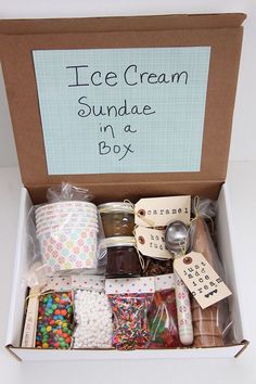 an ice cream sundae in a box filled with candies, marshmallows and more