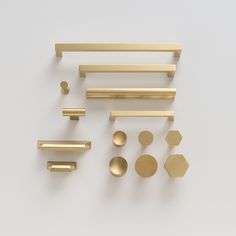 brass hardware and knobs on a white surface, including one for the cabinet door