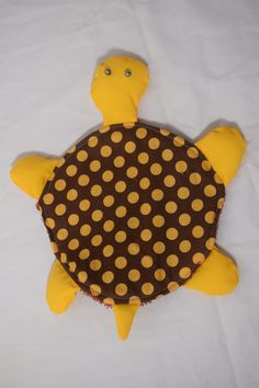 a stuffed turtle made out of brown and yellow polka dots