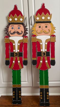 two wooden nutcrackers are standing next to each other in front of a door