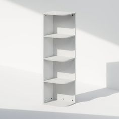 an empty white shelf against a white wall