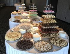 a buffet table filled with lots of different types of desserts and pastries on it