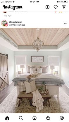 a bed room with a neatly made bed and a chandelier hanging from the ceiling