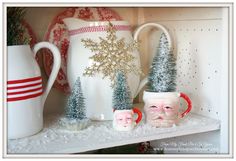 a shelf with christmas decorations and mugs on it