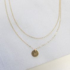 "Dainty Necklace - layered set of Two Simple and classic this layered set is the perfect compliment to your favorite tee or little black dress. This beautiful set is available in silver, gold or rose. D E T A I L S -Top layer - dainty link chain -Bottom layer- tiny disc measures 8mm -Choose 14kt Gold-Filled, Sterling Silver, or Rose Gold-Filled. -A high quality delicate link chain. -Polished to a light satin finish. CUSTOM HAND STAMPING -Hand stamped with an initial or heart. -This disc can also Dainty Adjustable Layered Necklaces, Dainty Double Chain Round Necklace, Dainty Layered Adjustable Necklaces, Dainty Round Necklace With Double Chain, Dainty Multi-strand Jewelry As Gift, Dainty Double Strand Adjustable Layered Necklace, Gift Multi-strand Double Chain Necklace, Minimalist Layered Double Strand Jewelry, Multi-strand Double Chain Necklace As A Gift