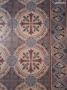 an old tile floor with decorative designs on it