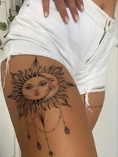 a woman's thigh with a sun tattoo on it