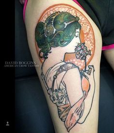 a woman's leg with a tattoo on it and an orange circle around her