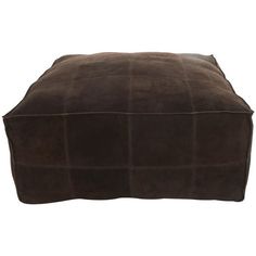 a brown square footstool sitting on top of a white floor