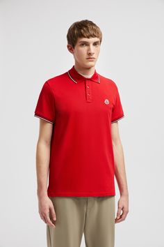 A timeless design that transcends seasons, this polo shirt is crafted from cotton pique. The classic style is embellished with a Moncler logo patch on the chest. Casual Red Polo Shirt With Ribbed Collar, Luxury Polo Shirt With Contrast Collar, Red Short Sleeve Polo Shirt With Ribbed Collar, Classic Red Polo Shirt With Striped Collar, Red Cotton Polo Shirt With Striped Collar, Sports Collared Polo Shirt With Moisture-wicking Fabric, Sporty Moisture-wicking Polo T-shirt, Moncler Logo, Classic Red Polo Collar T-shirt