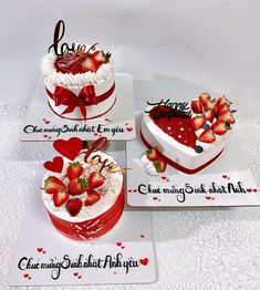 three heart shaped cakes with strawberries on top, one is white and the other is red