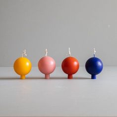 three candles are lined up in different colors