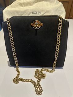 Vintage 1990's Beautiful Bally Bag. sophisticated and stylish and in beautiful condition.  Square in shape with a slight rise at the top. The Front is black suede leather with a Metal Turn-Lock fastener, the back, bottom and sides a black leather, with a nice long chain. The inside is fabric with a pocket and Bally Label.  Measurements : Length 8" Width 8" Depth 3" comes with the original Dust/storage Bag Bally Bag, Evening Handbag, Long Chain, Clutch Handbag, Black Suede, Evening Bags, Suede Leather, Purses And Handbags, Bag Storage