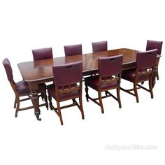 a large wooden table and chairs with purple leather upholstered seats on each side