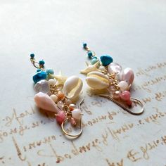 "Made to order. Important information on current production times may be found on the shop policies page or in the shop announcement. Now my long gemstone dangle earrings are available in a shorter version! *The first eight pictures are in gold filled, and the last is in sterling silver. ~ starfish, cowrie shells, sleeping beauty turquoise, pink Peruvian opal, rose quartz, larimar, turquoise, coral, grapefruit quartz, freshwater pearls, Swarovski crystals, angel skin coral ~ gold filled, rose go Artisan Beach Jewelry Set With Earrings, Turquoise Dangle Earrings Ocean-inspired, Turquoise Dangle Earrings With Ocean-inspired Style, Artisan Turquoise Earrings For Beach, Ocean-inspired Turquoise Dangle Jewelry, Turquoise Wire Wrapped Earrings For Beach, Turquoise Ocean-inspired Drop Earrings, Handmade Ocean-inspired Drop Earrings, Handmade Ocean-inspired Dangle Jewelry