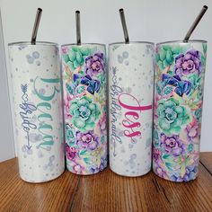 three personalized tumbles with floral designs on them