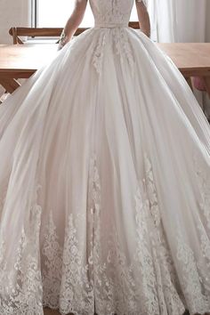 a woman in a wedding dress sitting at a table