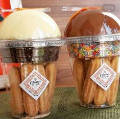 two plastic containers filled with donuts on top of a table