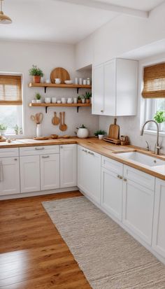 the kitchen is clean and ready for us to use it's white cabinetry