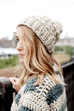 a woman wearing a knitted hat and scarf