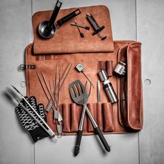 an assortment of kitchen utensils in a leather case