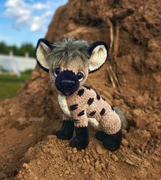 a stuffed animal sitting on top of a pile of dirt