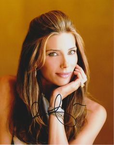 a beautiful young woman posing for a photo with her hand on her chin and looking at the camera